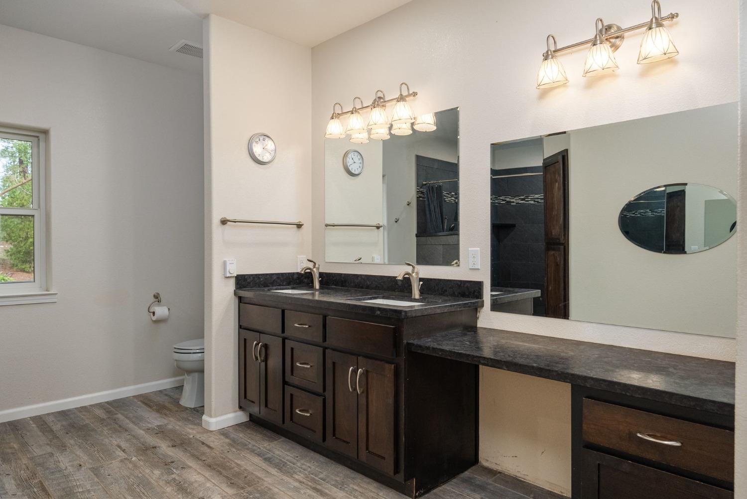 9080 El Dorado Trail Mountain Ranch, CA 95246 - Photo 27 of 44 a bathroom with a double vanity sink and a mirror