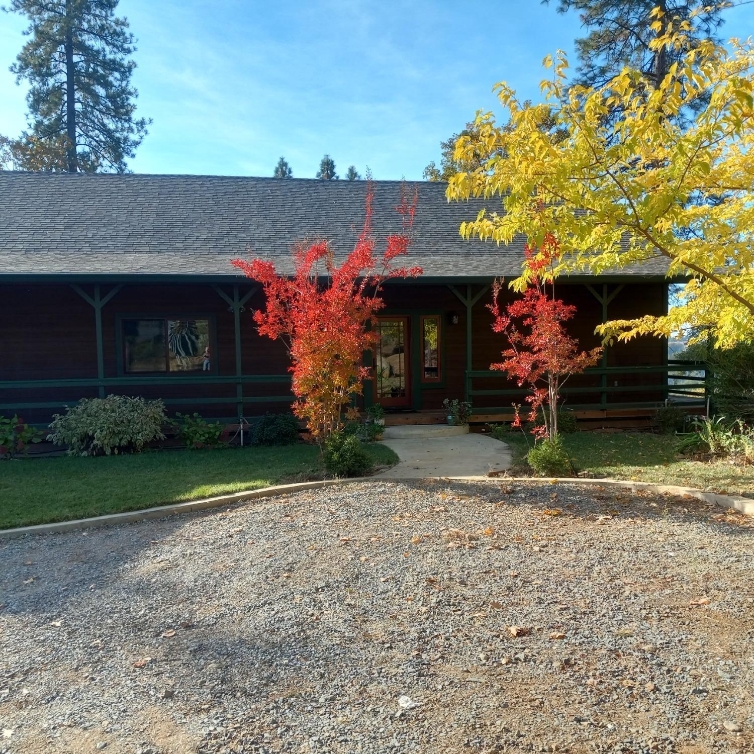 9080 El Dorado Trail Mountain Ranch, CA 95246 - Photo 3 of 44 a front view of a house with garden