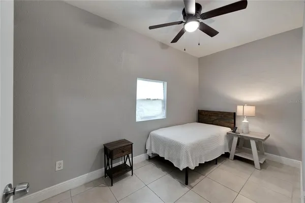 a bedroom with a bed and window