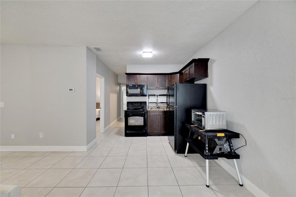 3651 Haines Road North St. Petersburg, FL 33704 - Photo 17 of 35 a kitchen with cabinets and refrigerator