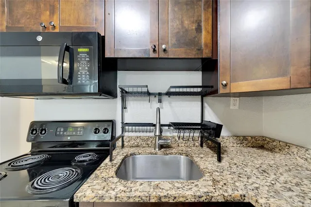 a kitchen with a sink and a stove top oven