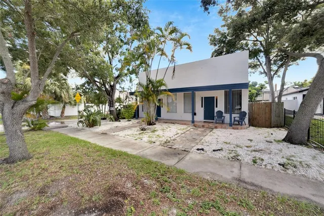a view of a house with a tree in the yard