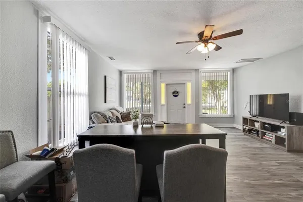 a kitchen with granite countertop a stove top oven a sink dishwasher and a refrigerator with wooden floor