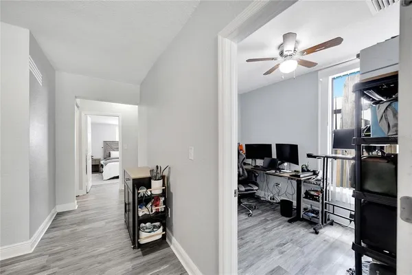 a view of a workspace with furniture and a window