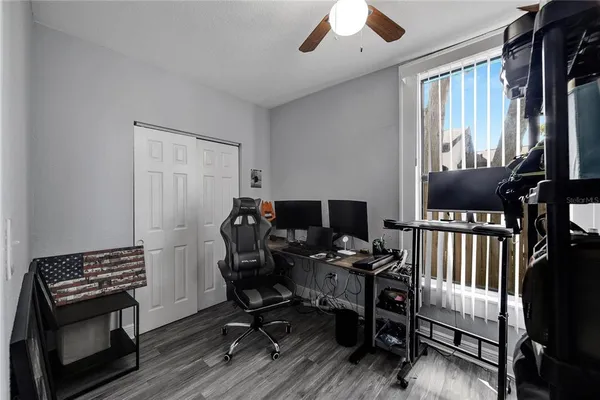 a view of a workspace with furniture and a window