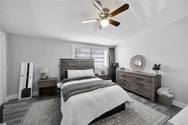 a bedroom with a bed and a large window