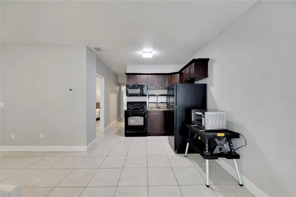 a kitchen with a refrigerator sink and stove top oven
