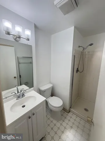 a white toilet and tub sitting next to a bathroom sink