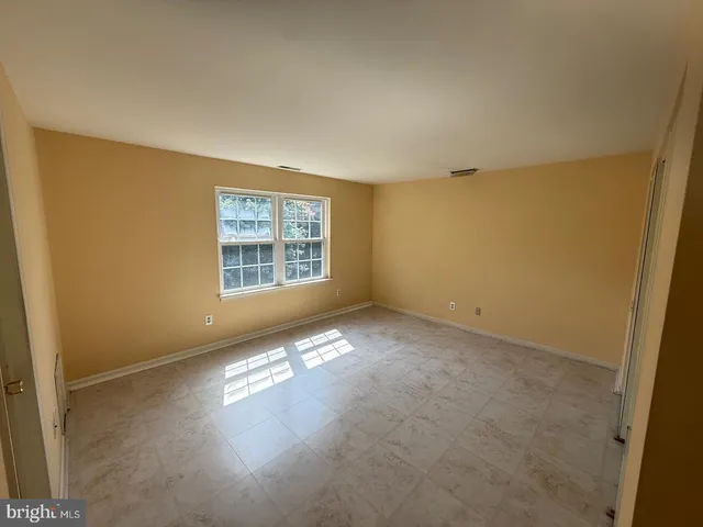 a view of a hallway with wooden walls