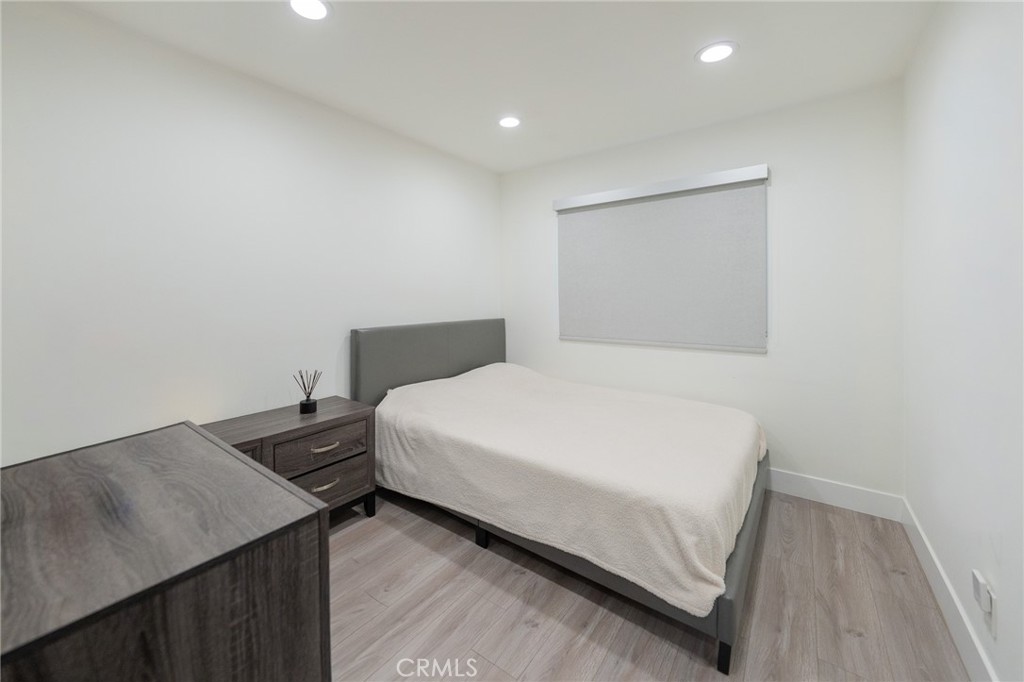 7719 Rhodes Avenue North Hollywood, CA 91605 - Photo 11 of 16 a bedroom with a bed and a table