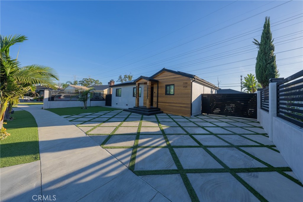 7719 Rhodes Avenue North Hollywood, CA 91605 - Photo 3 of 16 a front view of a house with a yard