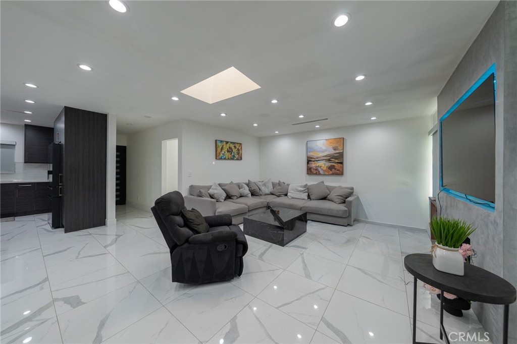 7719 Rhodes Avenue North Hollywood, CA 91605 - Photo 5 of 16 a living room with couches and kitchen view with wooden floor