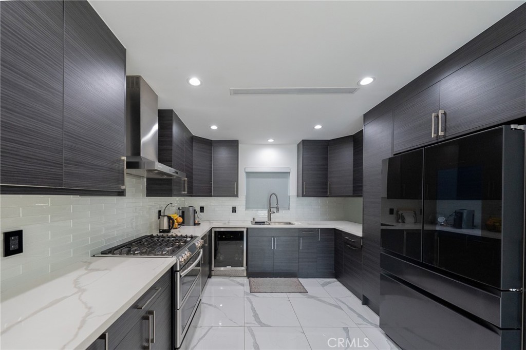 7719 Rhodes Avenue North Hollywood, CA 91605 - Photo 8 of 16 a kitchen with stainless steel appliances granite countertop a sink stove and refrigerator