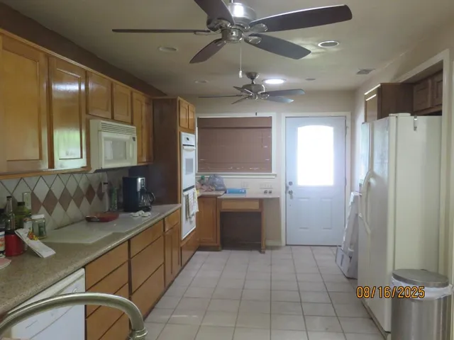a kitchen with a refrigerator and a sink