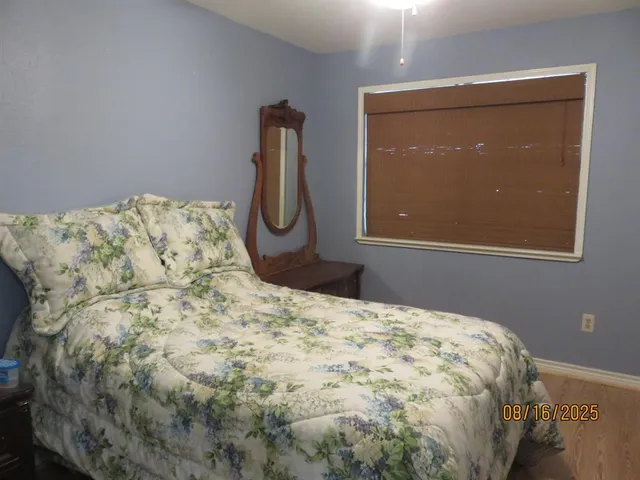 a bed sitting in a bedroom next to a window