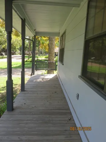 a view of swimming pool with wooden floor and seating space