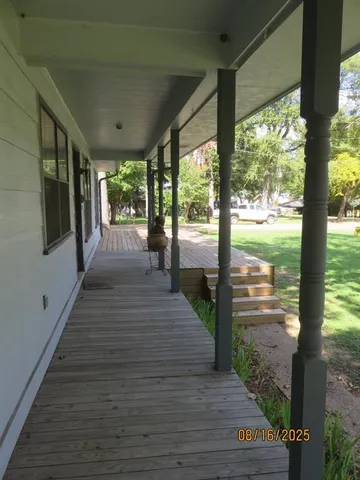 a view of a porch with wooden floor and stairs