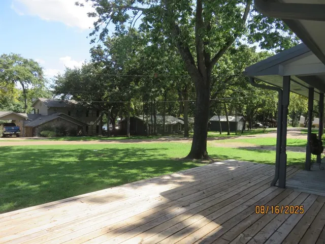 a view of a park with large trees