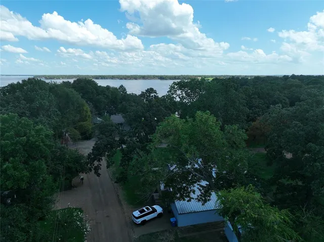 an aerial view of a house with a yard