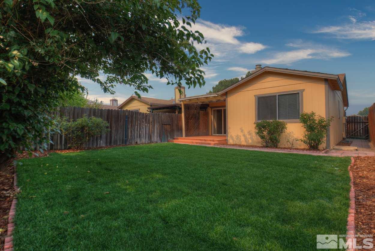 10034 Humite Lane Reno, NV 89506 - Photo 1 of 21 a front view of house with yard and green space