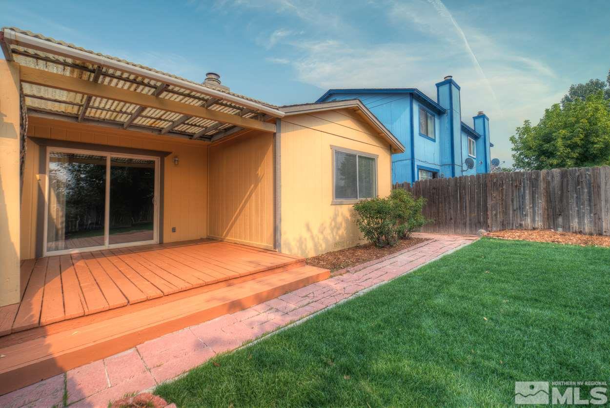 10034 Humite Lane Reno, NV 89506 - Photo 3 of 21 a backyard of a house with plants and wooden fence