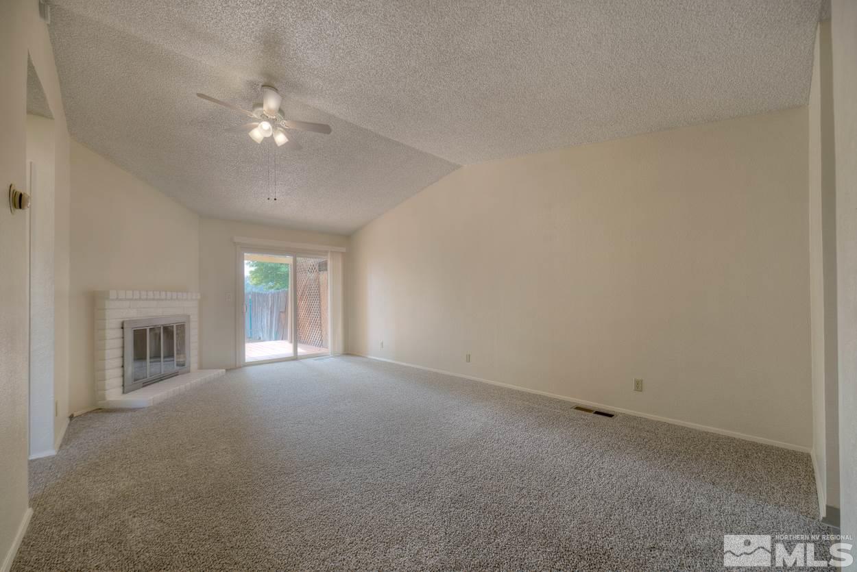 10034 Humite Lane Reno, NV 89506 - Photo 8 of 21 a view of a livingroom with an empty space and a ceiling fan