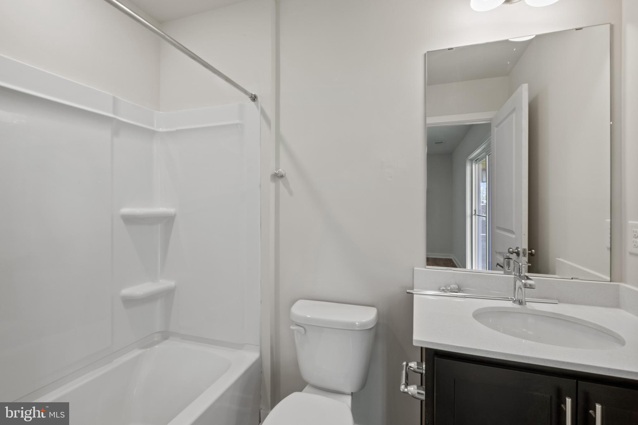 5019 Silver Oak Drive Rosedale, MD 21237 - Photo 15 of 43 a bathroom with a sink a toilet and shower