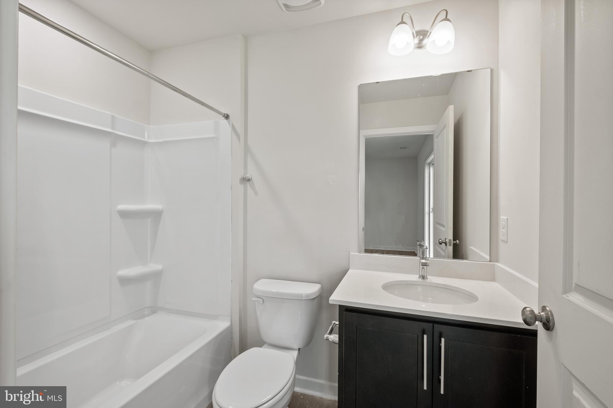 5019 Silver Oak Drive Rosedale, MD 21237 - Photo 16 of 43 a bathroom with a sink toilet and shower