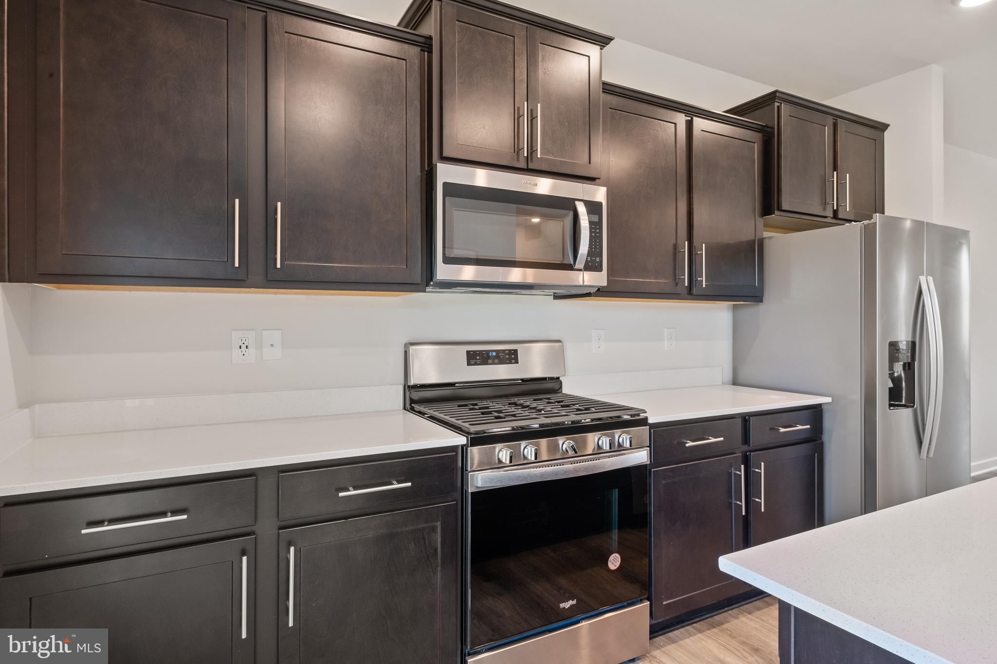 5019 Silver Oak Drive Rosedale, MD 21237 - Photo 10 of 43 a kitchen with stainless steel appliances granite countertop a sink a stove a refrigerator and cabinets