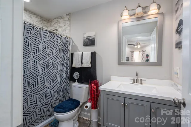 a bathroom with a sink toilet and mirror