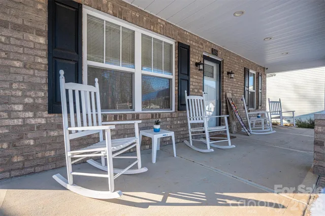 a view of a room with wooden floor and windows