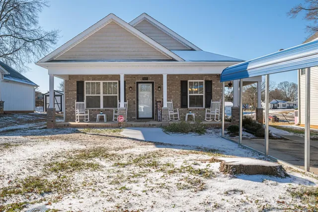 a view of a swimming pool with an outdoor seating and a yard