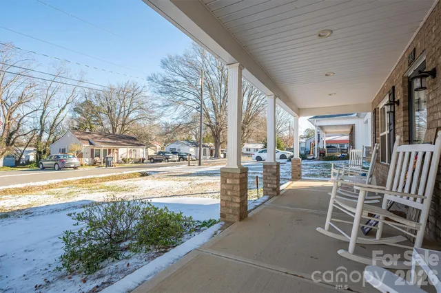 a view of a house with backyard porch and sitting area