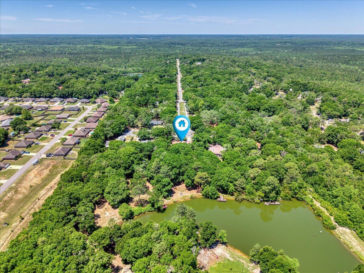 210 Shell Drive Crestview, FL 32536 - Photo 65 of 67 a backyard of a house with lots of green space and lake view