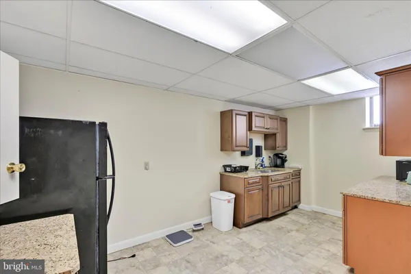 a view of an empty room with window and a potted plant