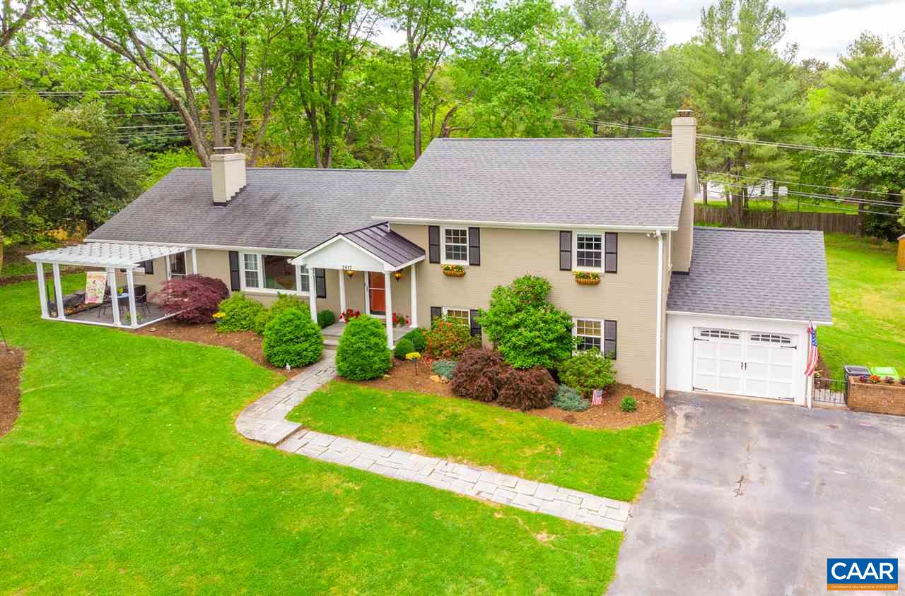 a aerial view of a house with a yard table and chairs