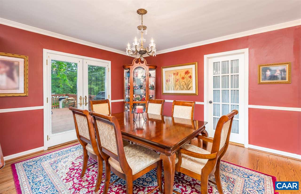 2417 Northfield Road Charlottesville, VA 22901 - Photo 14 of 47 a dining room with furniture a chandelier and wooden floor