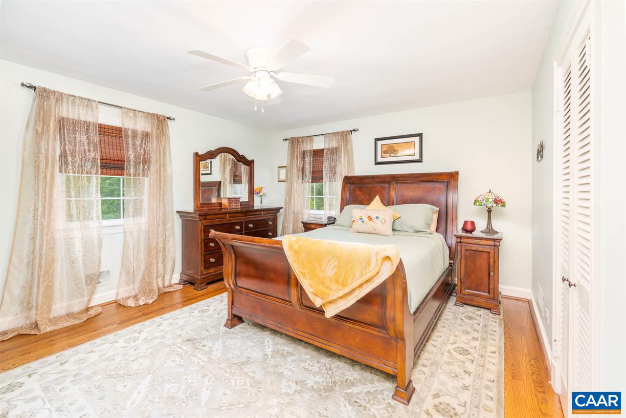 2417 Northfield Road Charlottesville, VA 22901 - Photo 16 of 47 a bedroom with a bed and dresser with mirror