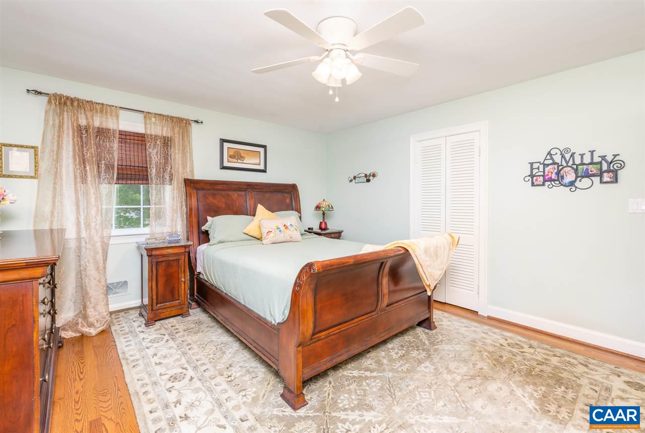2417 Northfield Road Charlottesville, VA 22901 - Photo 17 of 47 a bedroom with a large bed and a chandelier