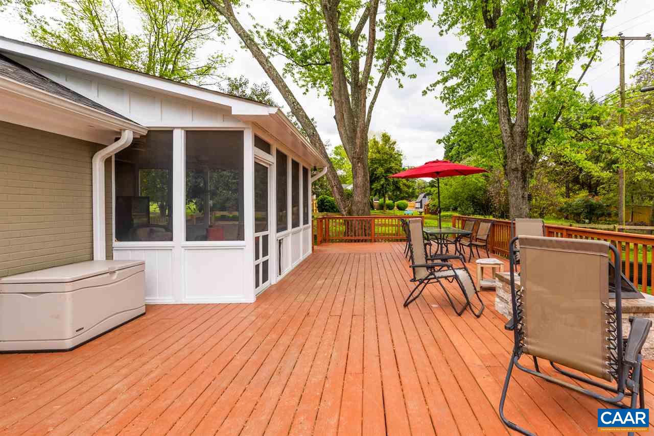 2417 Northfield Road Charlottesville, VA 22901 - Photo 35 of 47 a view of a patio with table and chairs under an umbrella with wooden floor