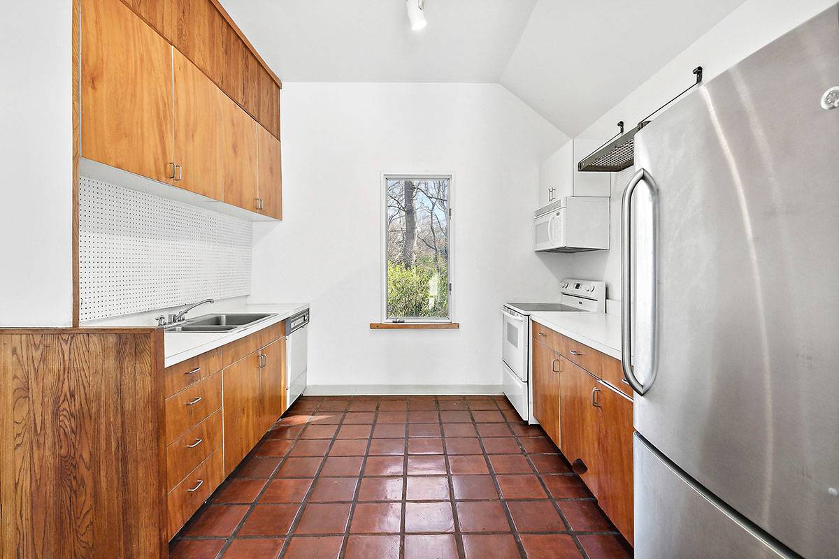 2855 Noyack Road Sag Harbor, NY 11963 - Photo 4 of 13 a kitchen with granite countertop a refrigerator and a sink