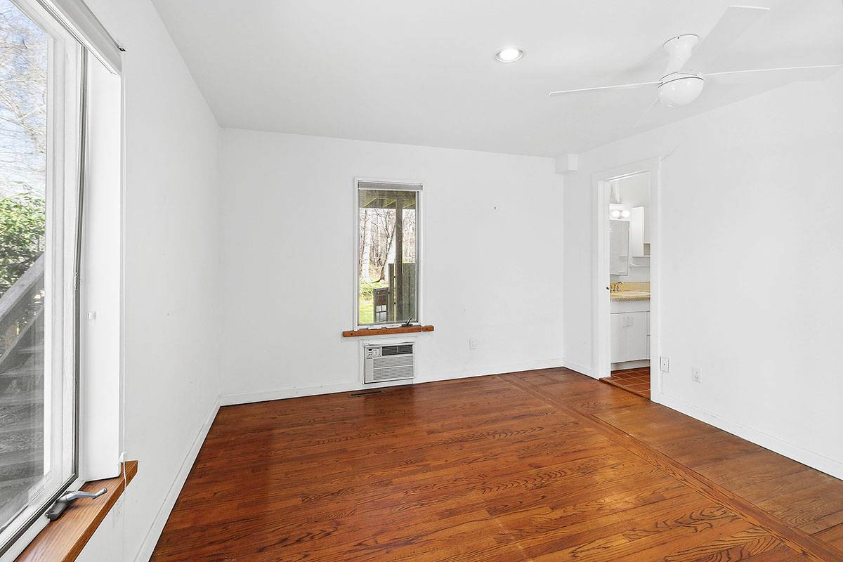 2855 Noyack Road Sag Harbor, NY 11963 - Photo 6 of 13 an empty room with windows and closet