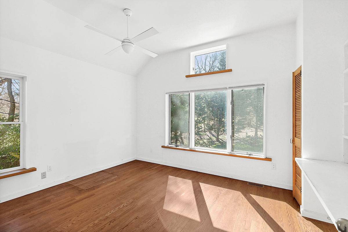 2855 Noyack Road Sag Harbor, NY 11963 - Photo 7 of 13 a view of an empty room with a window and wooden floor