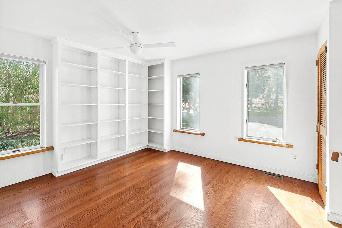 2855 Noyack Road Sag Harbor, NY 11963 - Photo 8 of 13 an empty room with wooden floor and windows