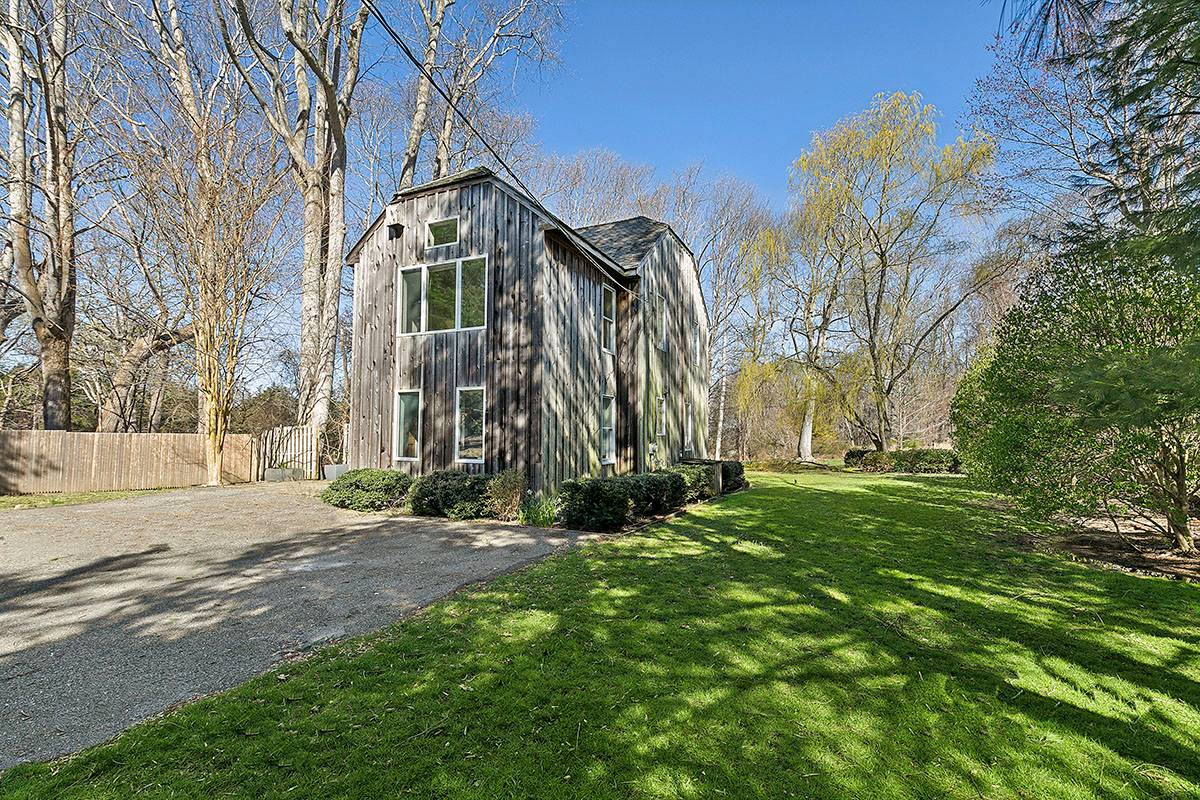 2855 Noyack Road Sag Harbor, NY 11963 - Photo 10 of 13 a front view of a house with a yard