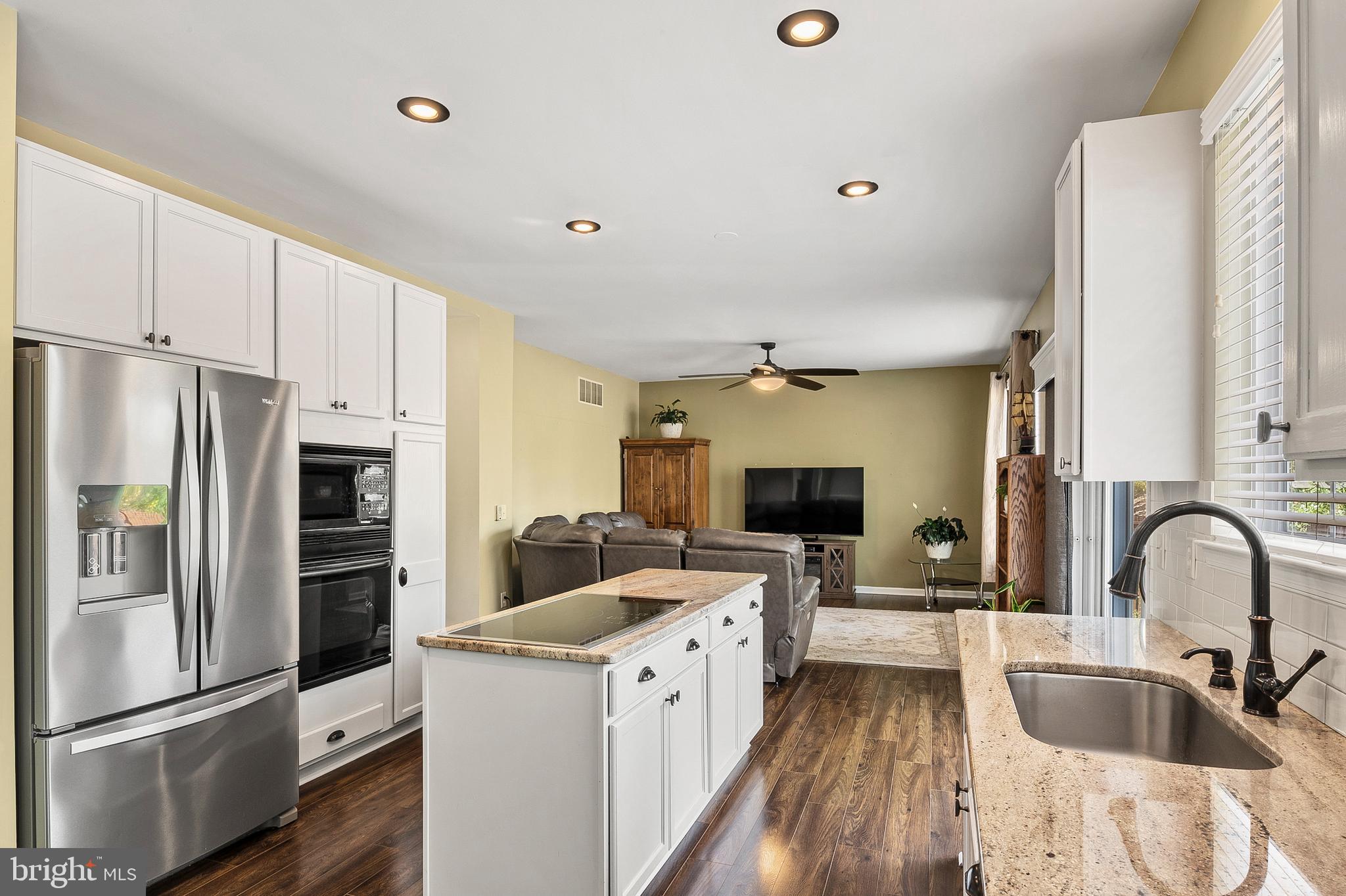 716 Wagner Farm Road Millersville, MD 21108 - Photo 12 of 45 a kitchen with a refrigerator sink and white cabinets