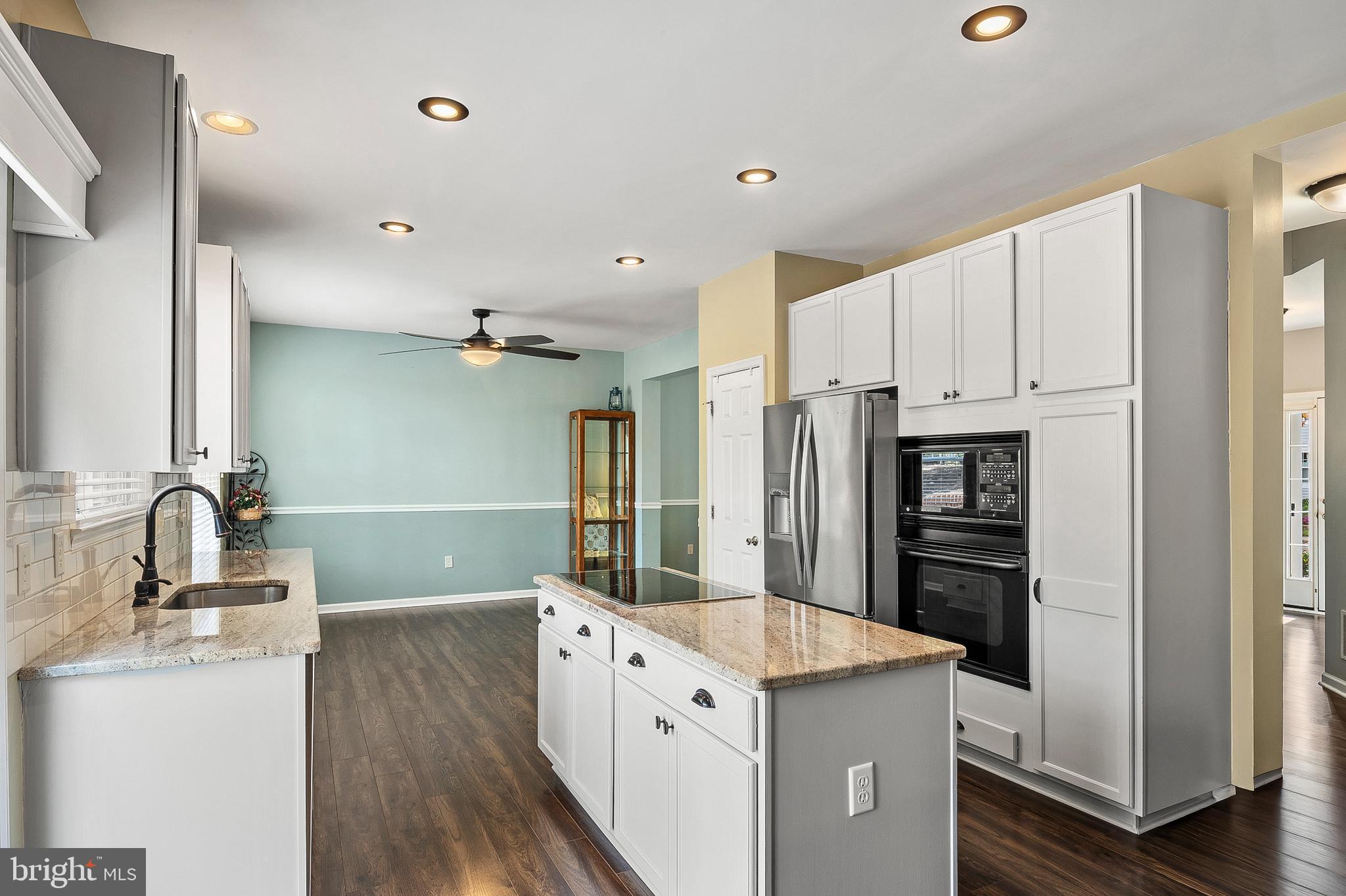 716 Wagner Farm Road Millersville, MD 21108 - Photo 13 of 45 a kitchen with kitchen island white cabinets and refrigerator