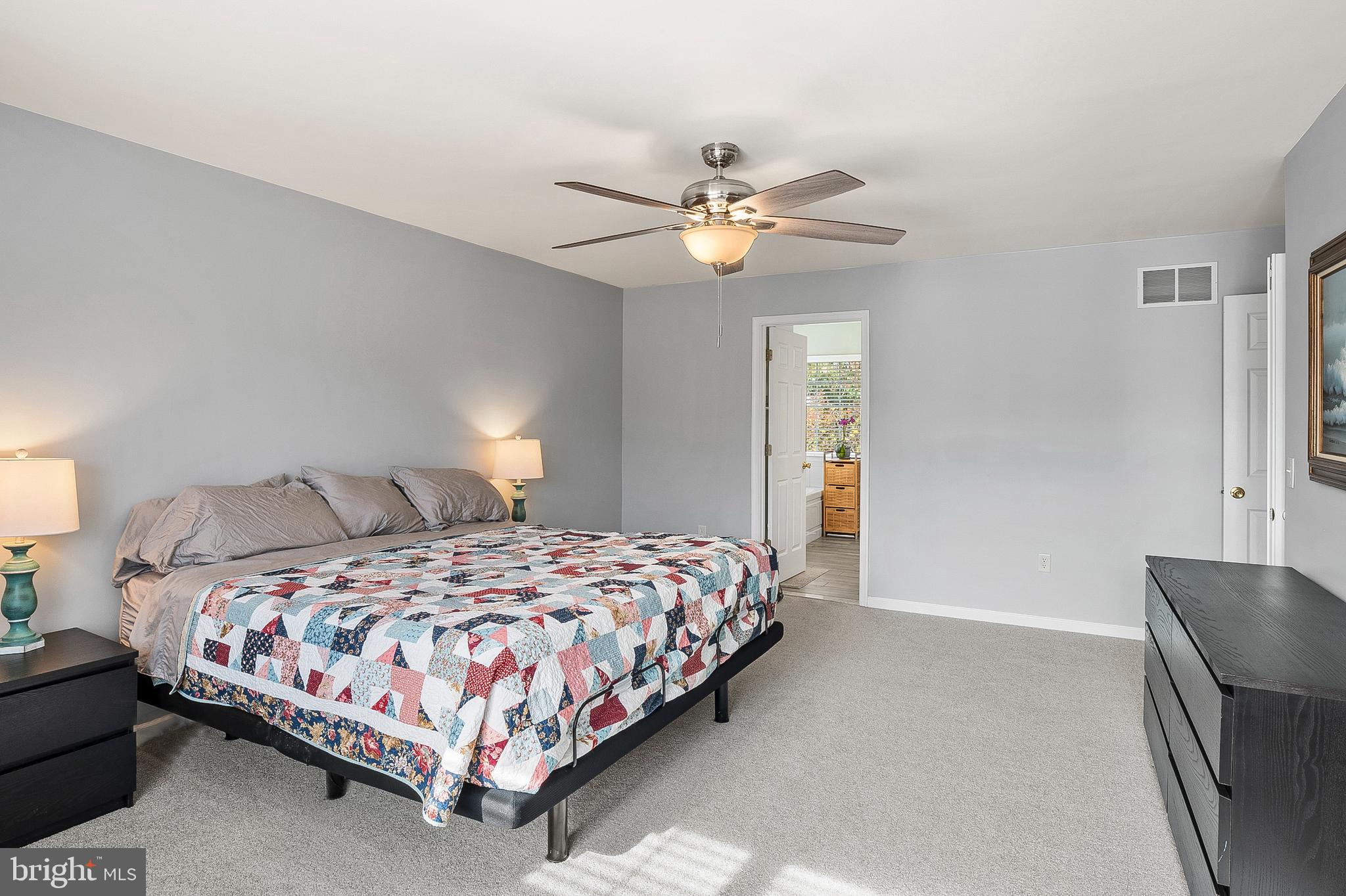 716 Wagner Farm Road Millersville, MD 21108 - Photo 25 of 45 a bedroom with a bed and a chandelier