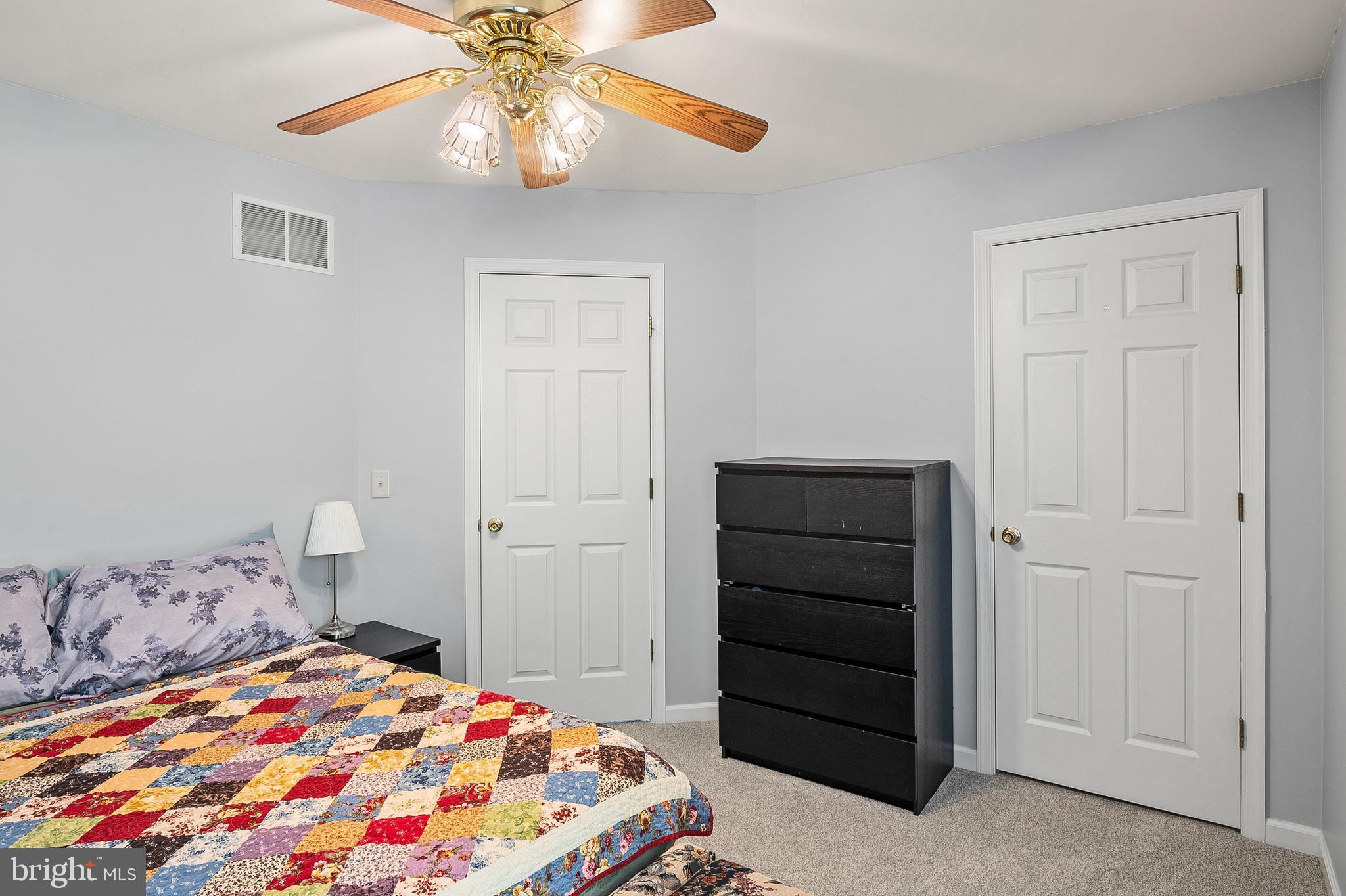 716 Wagner Farm Road Millersville, MD 21108 - Photo 33 of 45 a bedroom with a bed and a chandelier