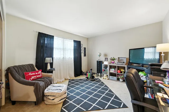 a bedroom with furniture and a flat screen tv